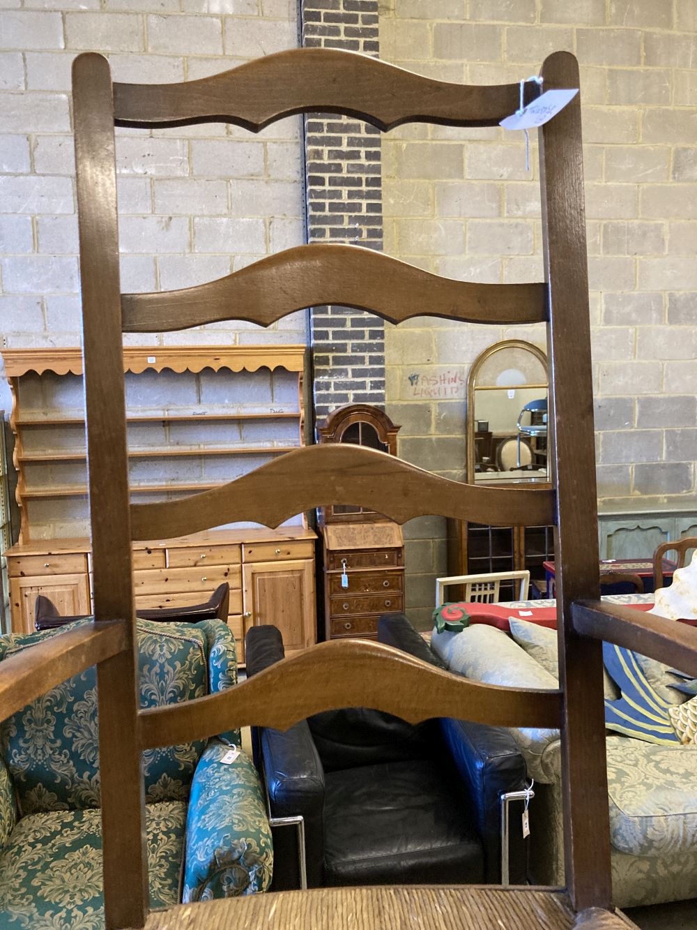 An Arts & Crafts ladder-back rush-seat elbow chair and an Edwardian inlaid mahogany three-tier cake stand (faults), 96cm high